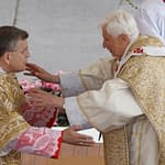 Pope Benedict XVI greets U.S. Cardinal Raymond L. Burke at the sign of peace during Easter Mass in St. Peter's Square at the Vatican April 8. (CNS photo/Paul Haring) (April 9, 2011) See POPE-EASTER April 8, 2011.